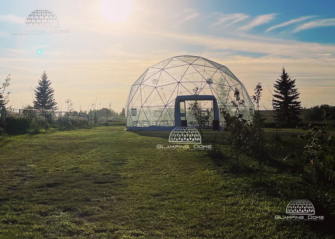 A 32-foot (10-meter) transparent PVC geodesic dome tent with a double door, located in Medicine Hat, Alberta, Canada. This inviting structure, a project by Glamping Dome Store, features an open door ready to welcome large groups for weddings, social gatherings, corporate events, and holiday setups, blending practicality with elegance in a picturesque rural setting.