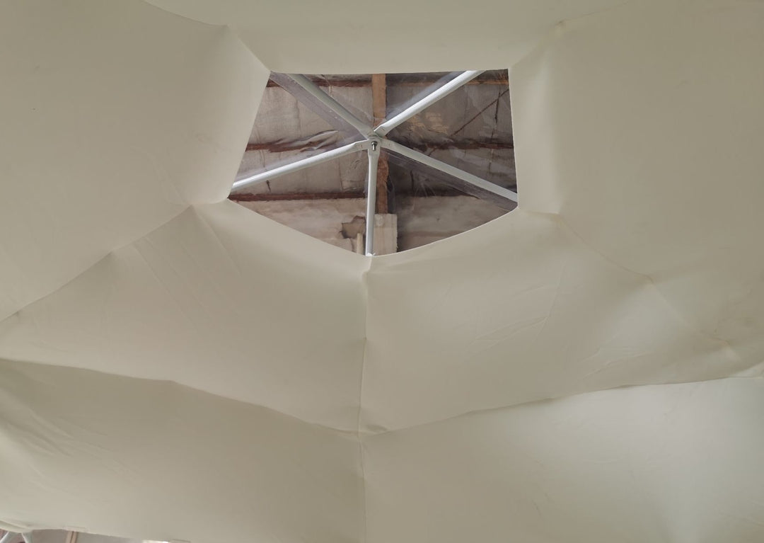 Stretchy dome decor space liner (1/8'' or 3 mm thick) in beige installed inside a Glamping Dome Store geodesic dome tent, featuring a skylight window at the top—perfect for glamping or those looking to buy a geodesic dome tent.