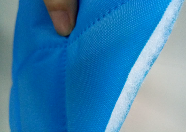 Close-up of the blue Quilted Synthetic Insulation Fabric Layer by Glamping Dome Store, designed for optimal temperature regulation in geodesic dome tents. This durable, multi-layered fabric is available in a thickness of 0.75 inches (20 mm) or 1.5 inches (40 mm) and offered in various colors to suit different aesthetic preferences. It enhances energy efficiency and comfort, making it ideal for outdoor accommodations and eco-friendly shelters.